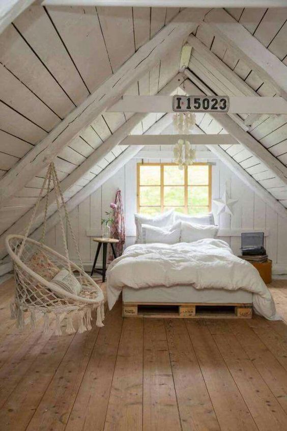Cozy bedroom in the attic with white wood material. #farmhouseatticsbedroomideas #vintageBedroom