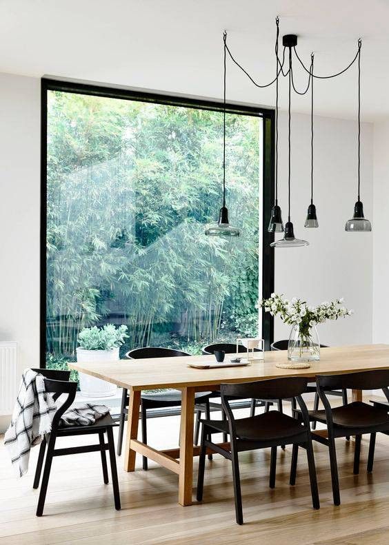 Scandinavian Design Inspired Interiors dining room with large window #blackchairs #diningroom
