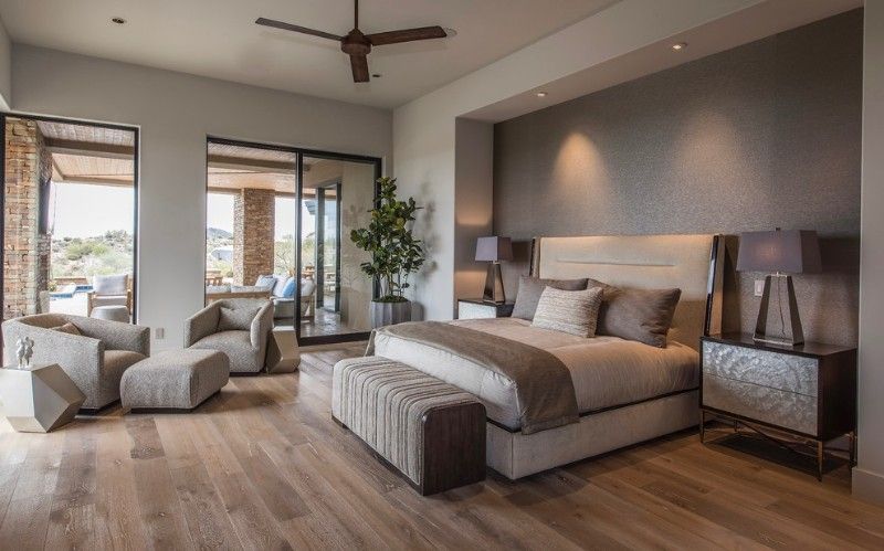 Large trendy master medium tone wood floor and brown floor bedroom .