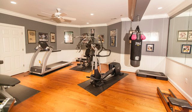 Home gym with large mirror and bright lighting - Traditional .