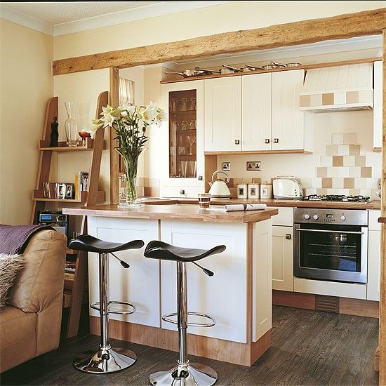 Open-plan country style kitchen-living room with breakfast bar .