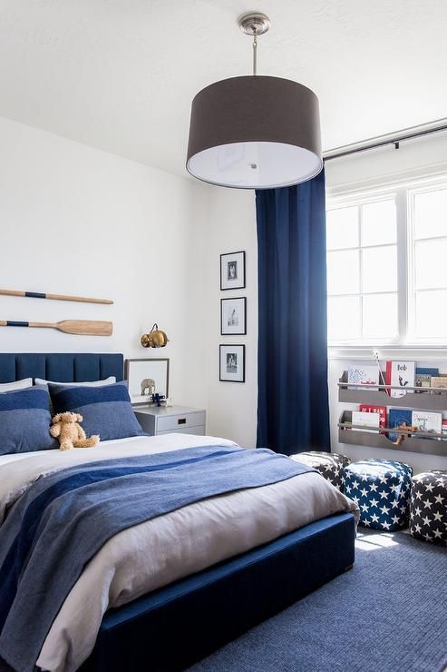 Gray Drum Pendant Over Dark Blue Upholstered Bed | Small room .