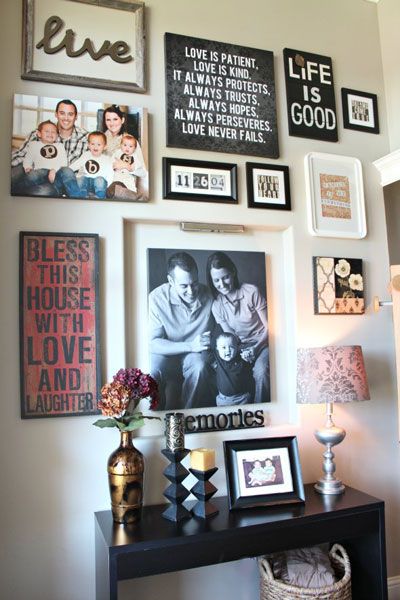 A gallery wall filled with artwork, framed family portraits and .