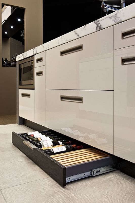 Toe kick drawer wine and drink storage. High gloss cabinets for .