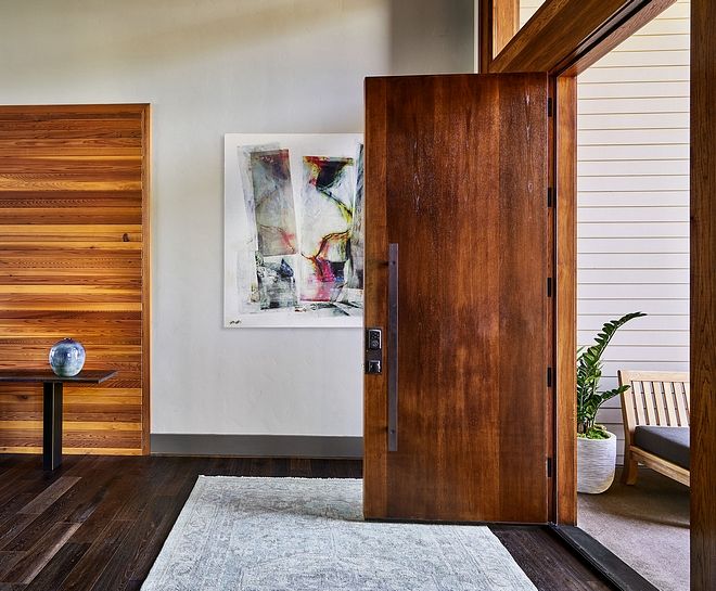 Modern Home Foyer Design A solid wood front door, dark hardwood .