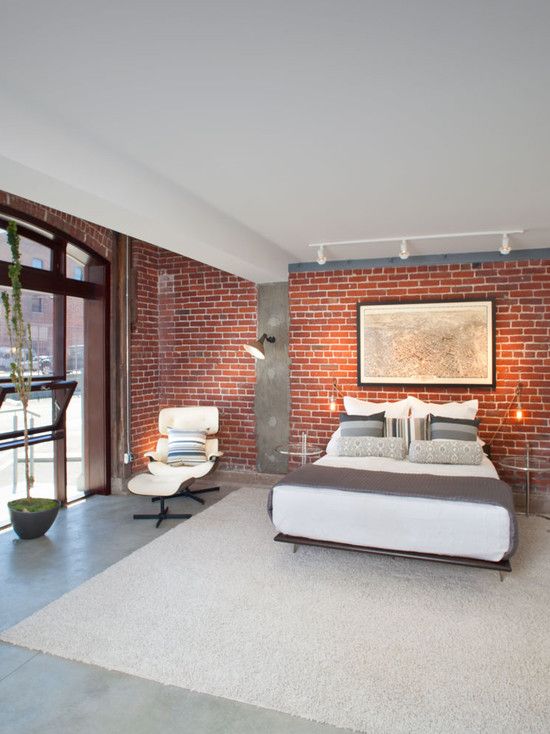 Beautiful red brick exposed wall combined with a cement screed .