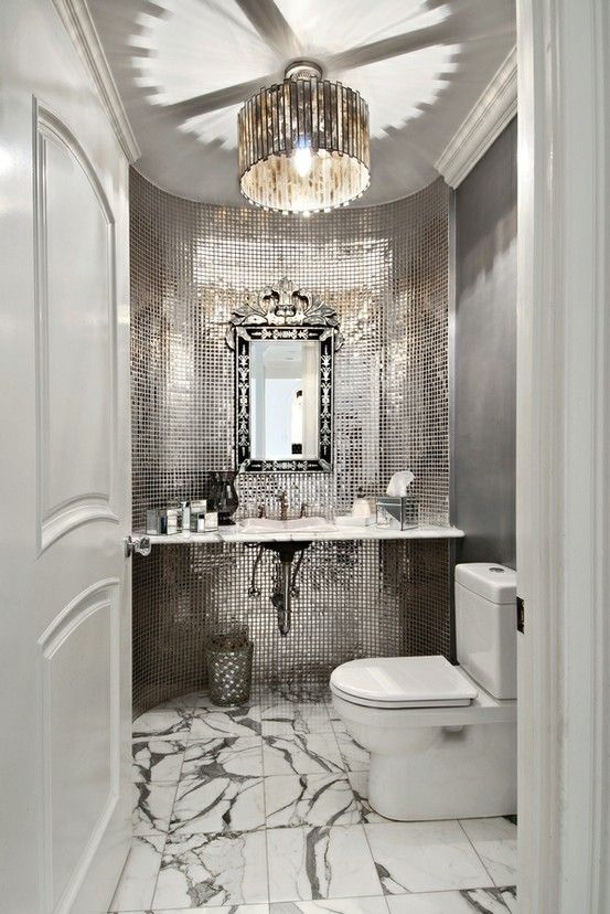 Gorgeous platinum grey silver powder room. Mirrored tile .