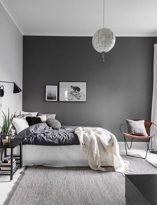 gray and white minimalist bedroom with a gray accent wall, gray .