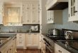 Perfect kitchen color scheme. Dark granite and cream cabinets with .