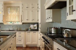 Perfect kitchen color scheme. Dark granite and cream cabinets with .
