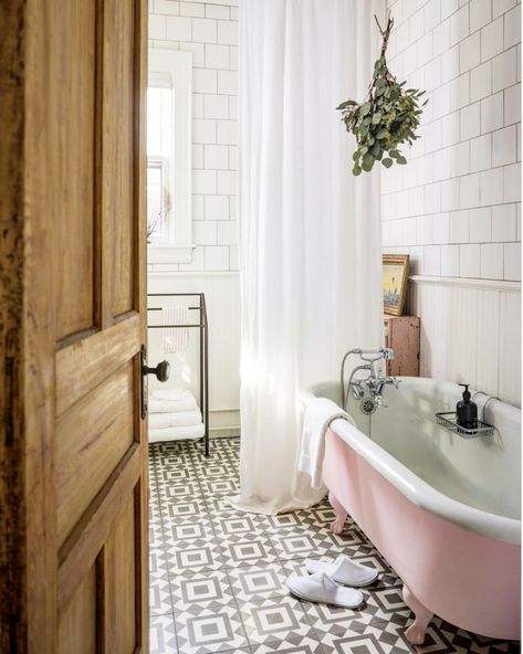 Old school style bathroom with black and white tiles and a pink .