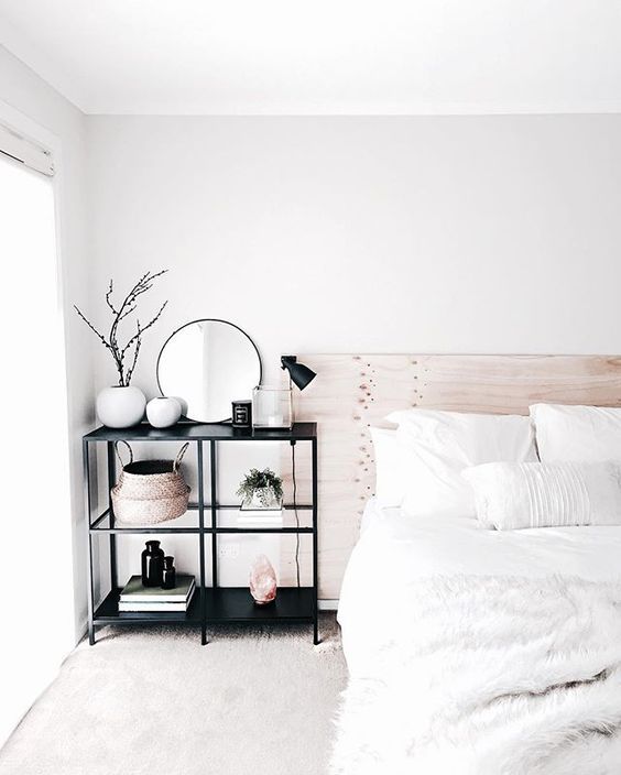 Modern minimal bedroom design featuring a bleached wood headboard .
