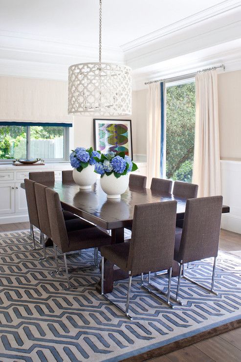 Gorgeous dining room with ivory and blue geometric rug over .